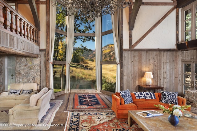 sunroom / solarium featuring an inviting chandelier