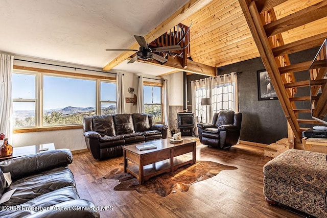 3547 Timberlane Dr Lot 586, Craig, CO 81625 - living room with a wood stove, ceiling fan, wood-type flooring, beamed ceiling, and stairs