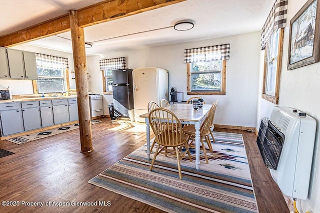 3547 Timberlane Dr Lot 586, Craig, CO 81625 - dining area featuring dark wood-style flooring, heating unit, beam ceiling, and baseboards