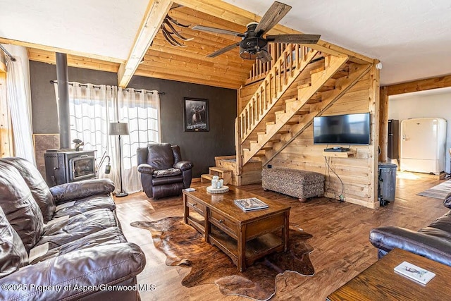 3547 Timberlane Dr Lot 586, Craig, CO 81625 - living room with a wood stove, stairway, ceiling fan, wood finished floors, and beam ceiling