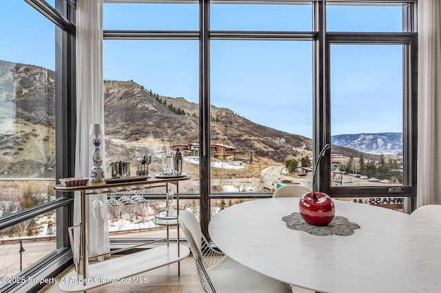 unfurnished dining area featuring a mountain view