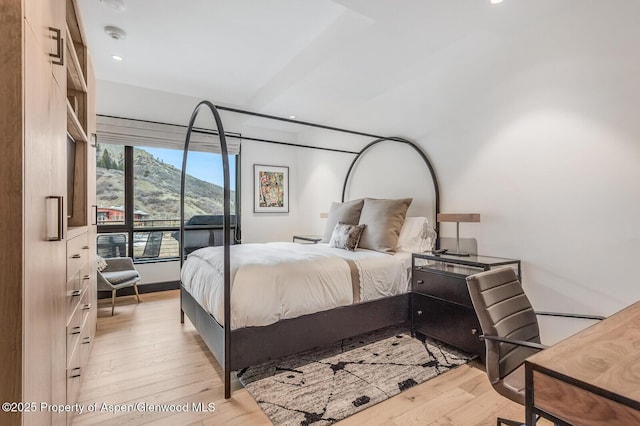 bedroom featuring a mountain view and light hardwood / wood-style floors