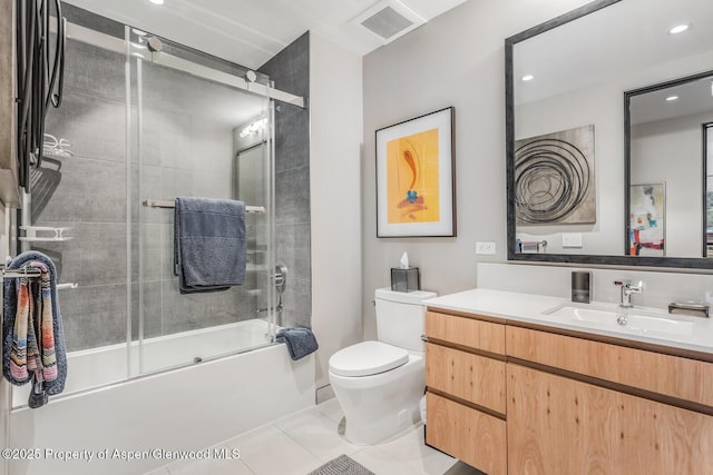 full bathroom featuring vanity, tile patterned flooring, shower / bath combination with glass door, and toilet