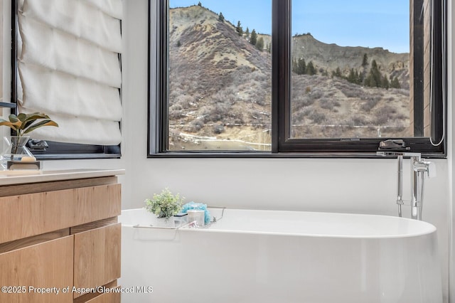 bathroom with a mountain view and a bathtub