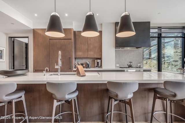 kitchen with pendant lighting, a kitchen bar, and tasteful backsplash