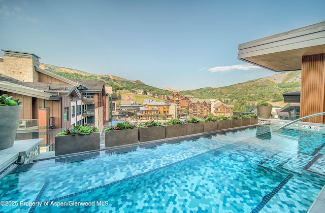 view of swimming pool featuring a mountain view