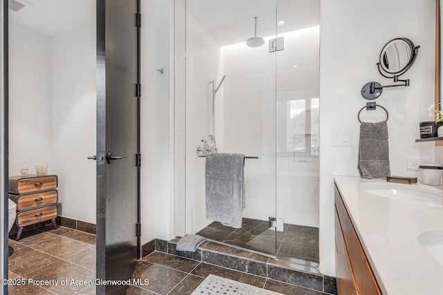 bathroom with vanity and a shower with shower door