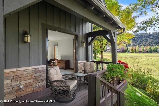 wooden deck featuring a yard