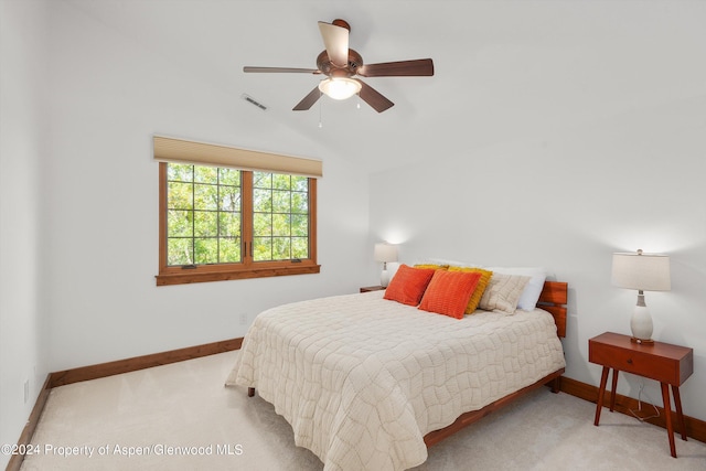 carpeted bedroom featuring lofted ceiling and ceiling fan