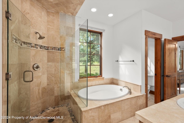 full bathroom with toilet, vanity, and shower with separate bathtub