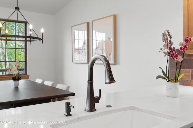 dining room with sink and an inviting chandelier