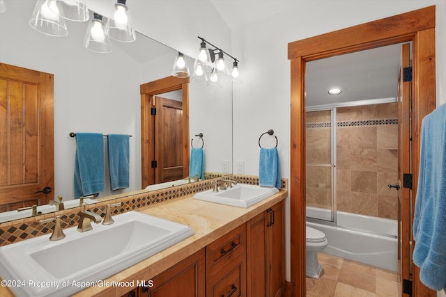 full bathroom with vanity, shower / bath combination with glass door, and toilet