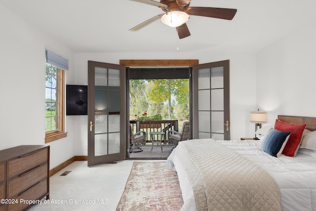 bedroom with light carpet, french doors, ceiling fan, and access to outside