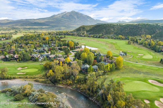 drone / aerial view featuring a water and mountain view