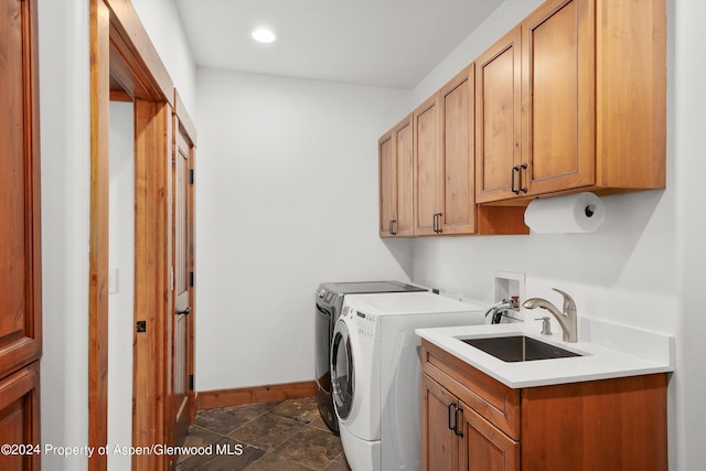 laundry area with washer and clothes dryer, sink, and cabinets