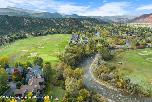 drone / aerial view with a water and mountain view