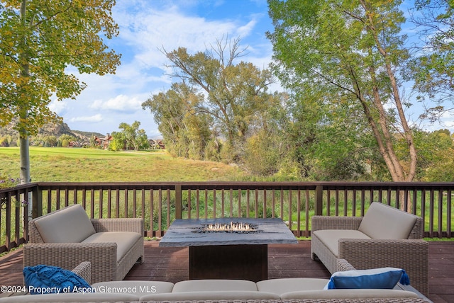 wooden terrace featuring a fire pit