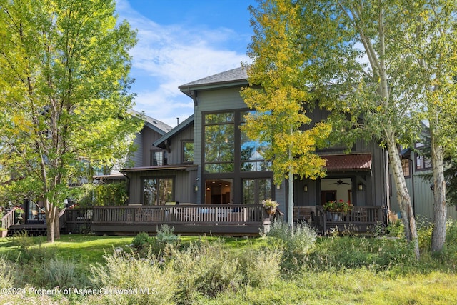 back of house with a deck and a sunroom