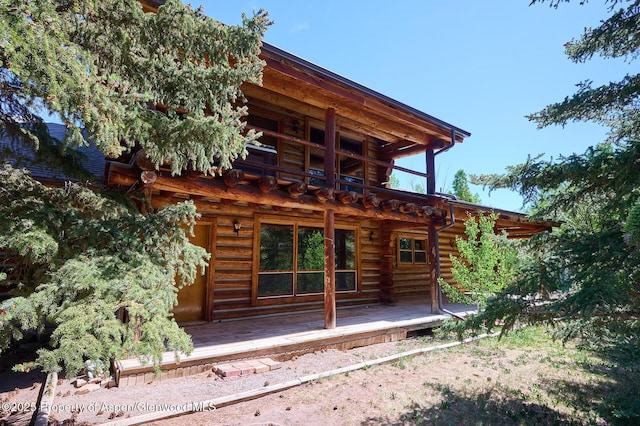 63 Alexander Ave, Snowmass, CO 81654 - rear view of house with log siding, a wooden deck, and a balcony