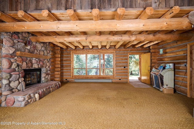 63 Alexander Ave, Snowmass, CO 81654 - unfurnished living room with a wooden ceiling with exposed beams, a baseboard radiator, carpet, log walls, and a stone fireplace