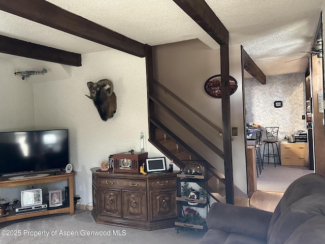 595 Colorado St, Craig, CO 81625 - living area featuring a textured ceiling, beamed ceiling, stairway, carpet, and a textured wall
