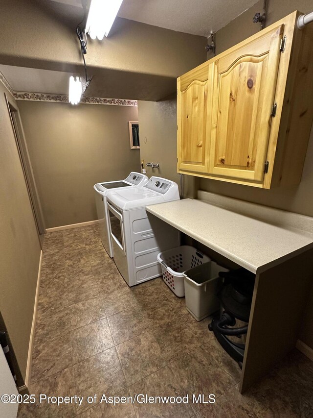 595 Colorado St, Craig, CO 81625 - laundry area with cabinet space, washer and clothes dryer, and baseboards