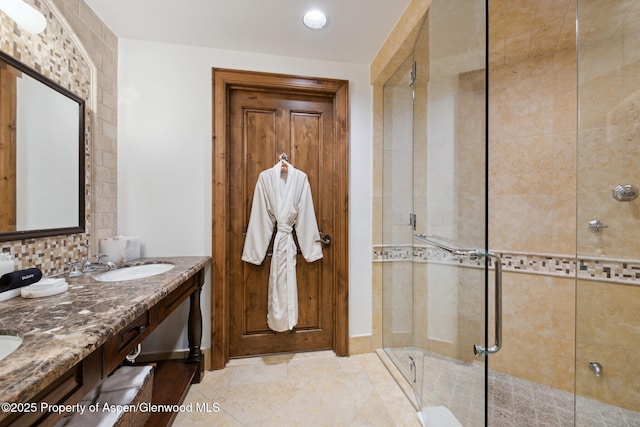 bathroom featuring vanity and an enclosed shower