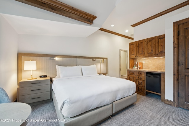 carpeted bedroom featuring bar area