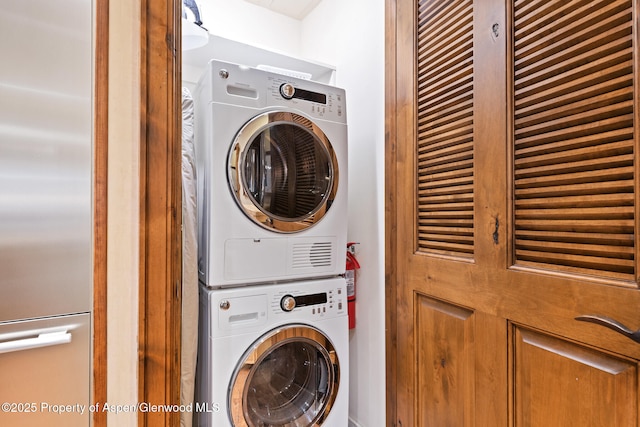 clothes washing area featuring stacked washer / drying machine