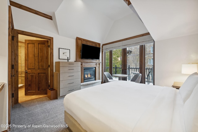 bedroom with lofted ceiling, carpet flooring, and access to outside