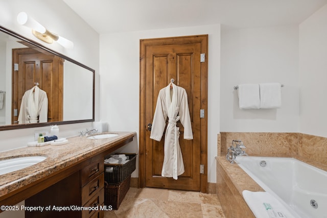 bathroom with vanity and tiled tub