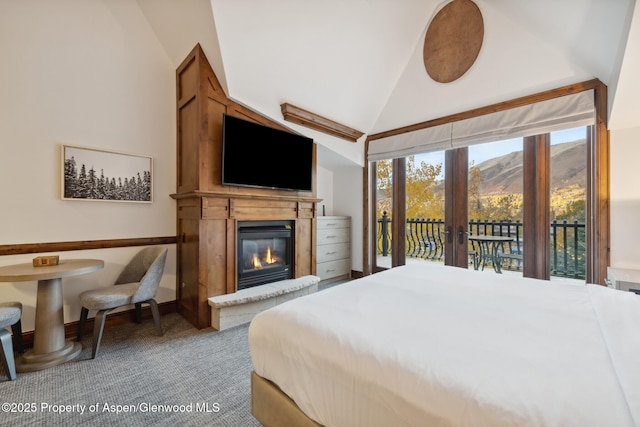 carpeted bedroom with lofted ceiling, access to exterior, and french doors