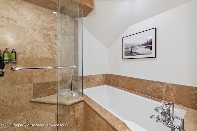 bathroom with lofted ceiling and separate shower and tub