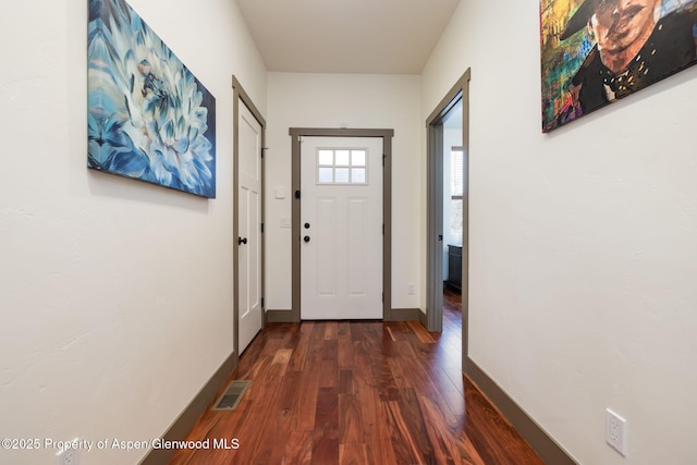 entryway featuring dark wood-style flooring, visible vents, and baseboards