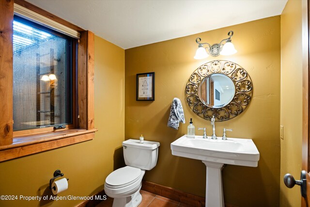 bathroom with tile patterned flooring and toilet