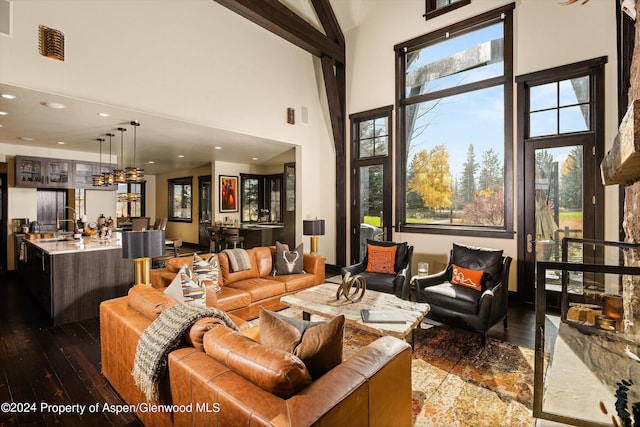 living room with beam ceiling, high vaulted ceiling, and dark wood-type flooring