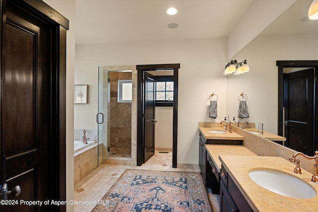 bathroom featuring vanity and shower with separate bathtub