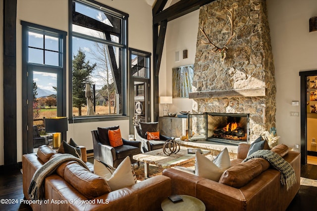 interior space featuring a fireplace, hardwood / wood-style floors, and a towering ceiling