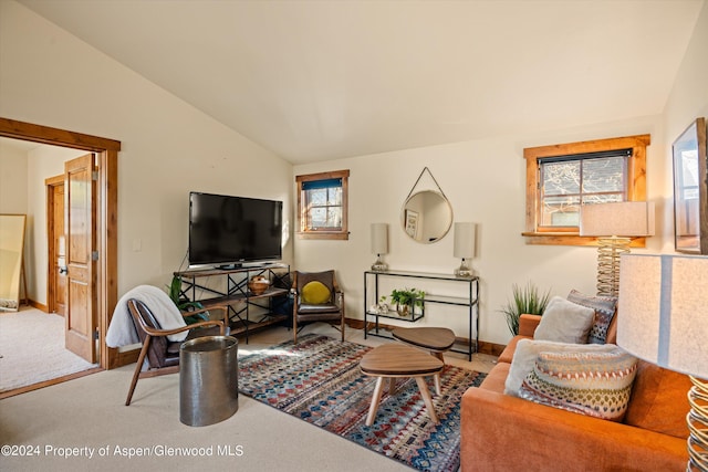 carpeted living room featuring vaulted ceiling