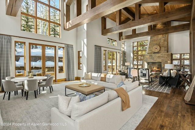 living room with dark hardwood / wood-style flooring, beam ceiling, high vaulted ceiling, wooden ceiling, and a fireplace