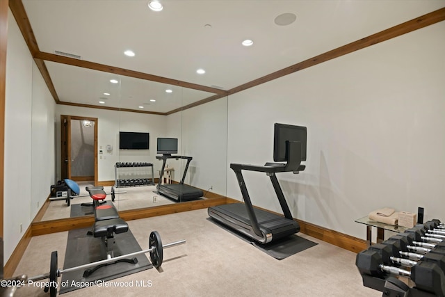 exercise area featuring light colored carpet and ornamental molding