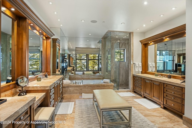 bathroom with vanity and independent shower and bath