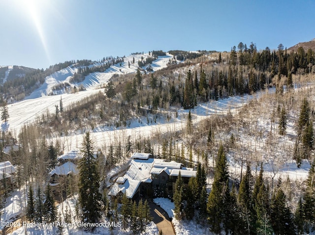 snowy aerial view featuring a mountain view