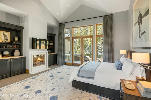 bedroom with access to exterior, french doors, light colored carpet, and vaulted ceiling