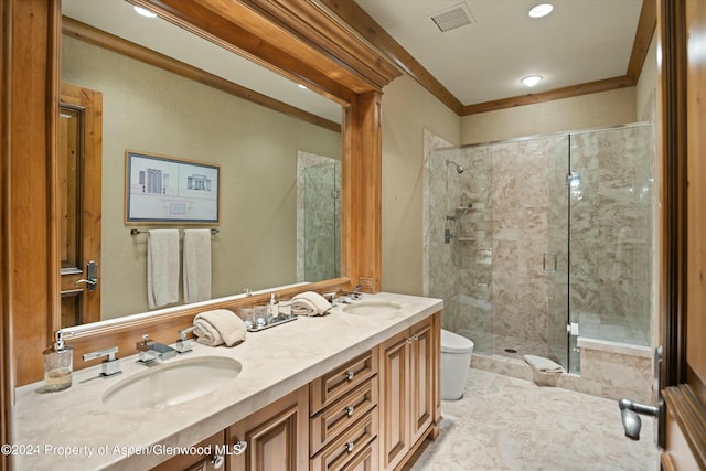 bathroom with vanity, toilet, ornamental molding, and walk in shower