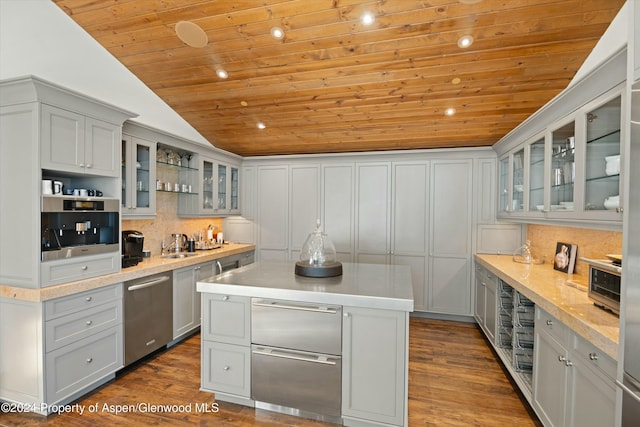 kitchen featuring a center island, vaulted ceiling, hardwood / wood-style flooring, decorative backsplash, and wood ceiling