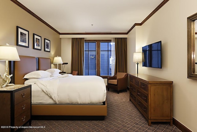 bedroom featuring crown molding, baseboards, and dark colored carpet