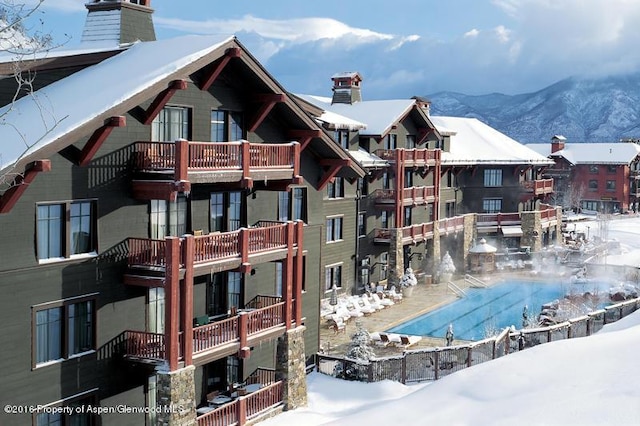 snow covered pool featuring a community pool and a mountain view
