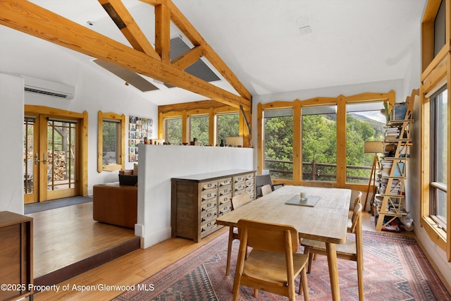 116 S Bill Creek Rd, Carbondale, CO 81623 - dining space with french doors, an AC wall unit, plenty of natural light, and wood finished floors