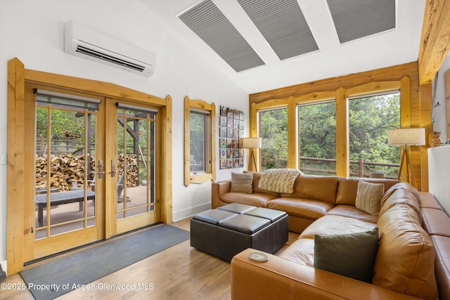 116 S Bill Creek Rd, Carbondale, CO 81623 - living room featuring a wall mounted AC, wood finished floors, healthy amount of natural light, french doors, and high vaulted ceiling